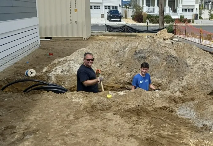 Ryan Fisher working in the trenches with his son